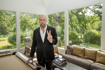 John Paul DeJoria giving peace sign.